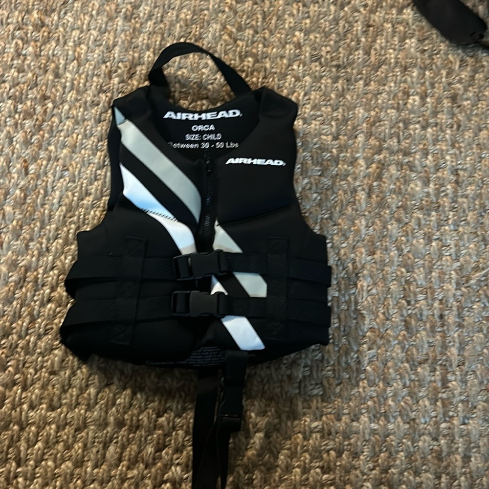 Black neoprene toddler life vest.